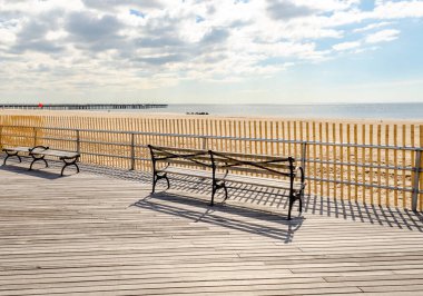 Coney Adası Sahil Alanı 'ndaki banklarda Ocean ve Pat Auletta Çıkıntılı İskelesi arkada, NYC