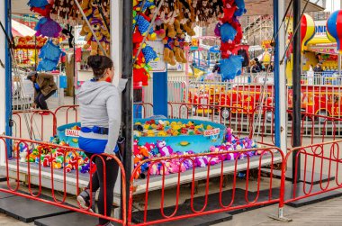 Ördek avlama standında müşteri bekleyen bir kadın. Luna Park, Coney Adası, New York.
