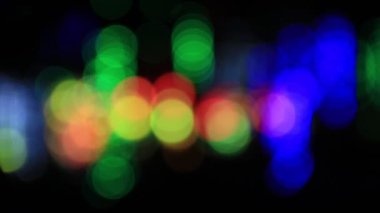 Odak dışında çok renkli ışıklar arka plan bulanık. Loopable soyut hareket daire bokeh ışıklar