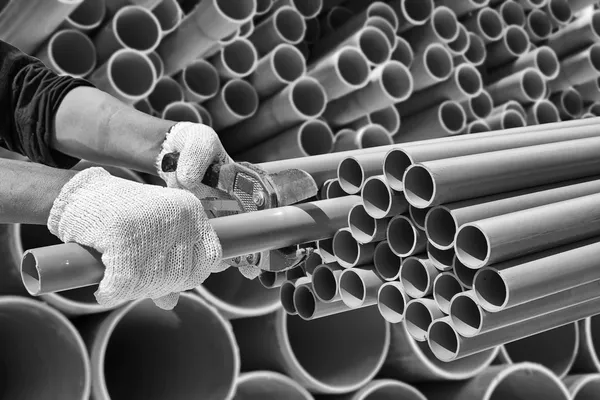 Worker cut pvc pipe in construction site — Stock Photo, Image