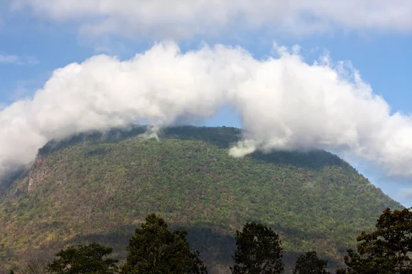 Cloud climbing a mountain — Stock Photo, Image