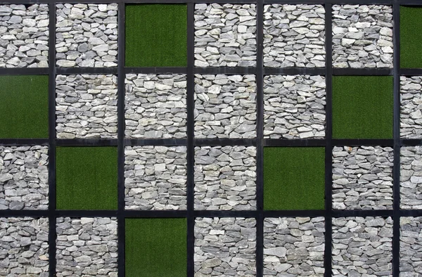 Artificial grass and stone pattern wall. — Stock Photo, Image