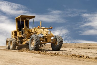 Motor grader working on road construction clipart