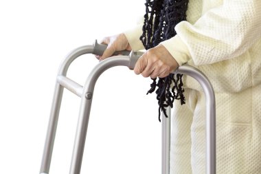 Yürüteç kullanan yaşlı bir kadın.