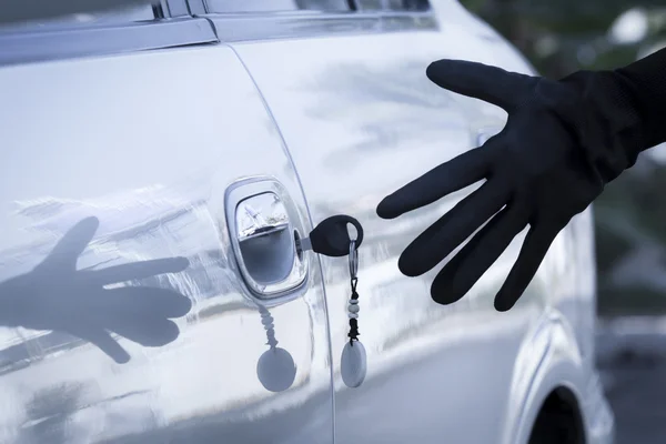 Left key on the car door at parking lot — Stock Photo, Image