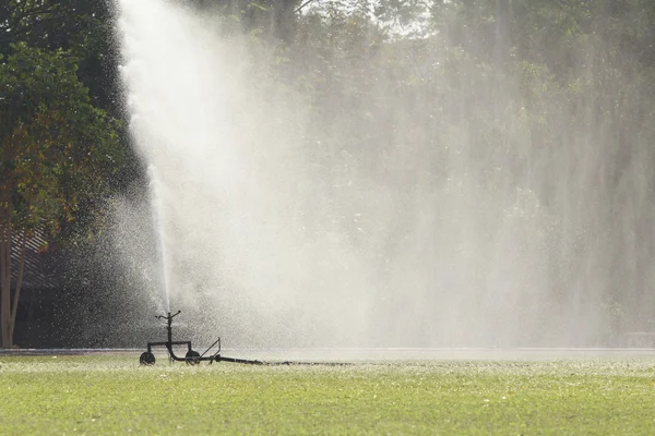 Sprinkler head watering the grass — Stock Photo, Image