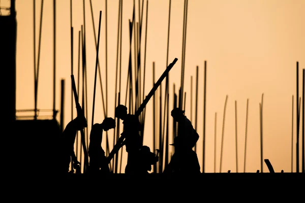 Construction worker silhouette on the work place — Stock Photo, Image