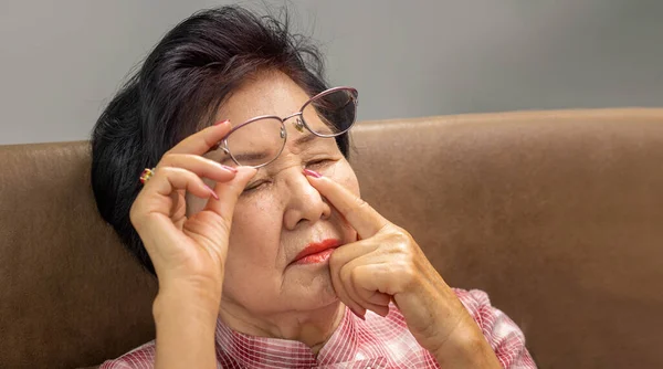 Asian Senior Older Woman Taking Glasses Suffering Dry Eyes Syndrome — Stockfoto