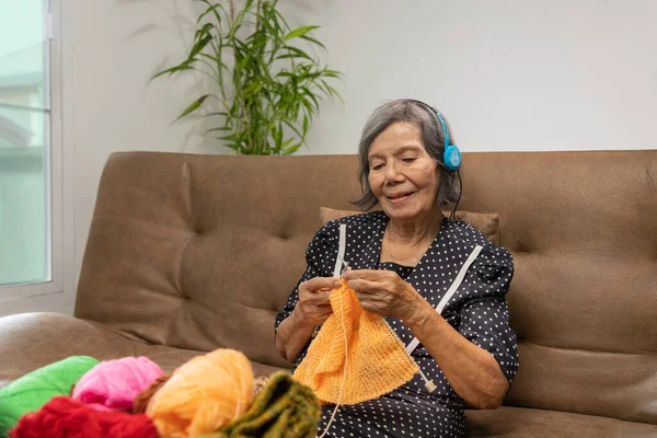Music and Knitting therapy in dementia treatment on elderly woman.
