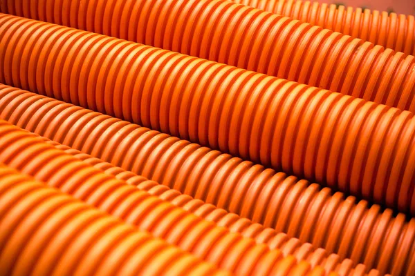 Orange plastic PVC pipes on industrial
