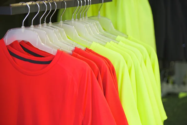 red and yellow shirts on hangers fashion boutique