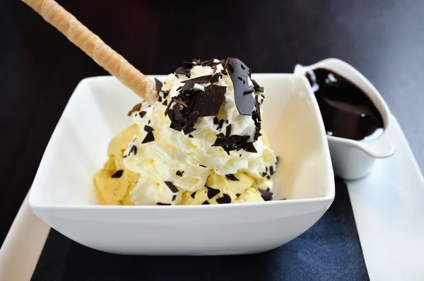 Ice-cream Dame Blanche with chocolate sauce on dark background — Stock Photo, Image