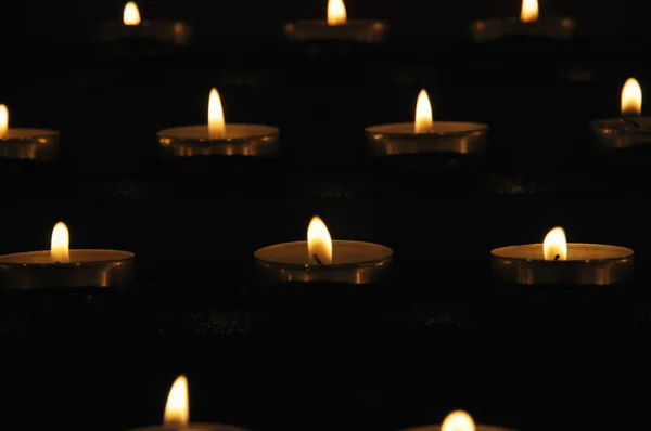 Церковные свечи на темной стене — стоковое фото