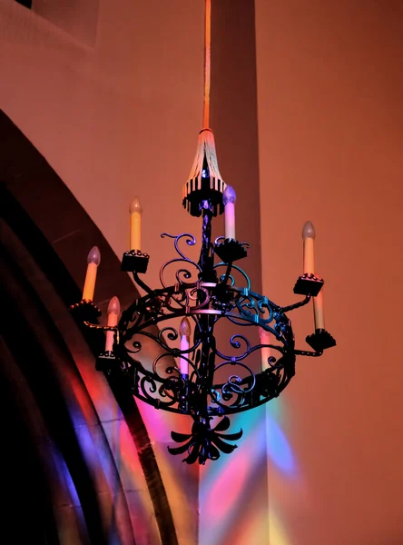Church chandelier in Strasbourg, France with reflections from stained glass windows — Stock Photo, Image