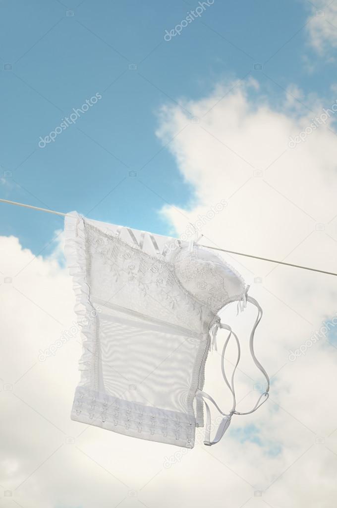 White bustier after washing on blue sky background