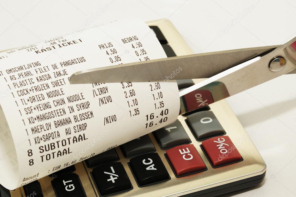Economy concept image with scissors cutting receipt from shop