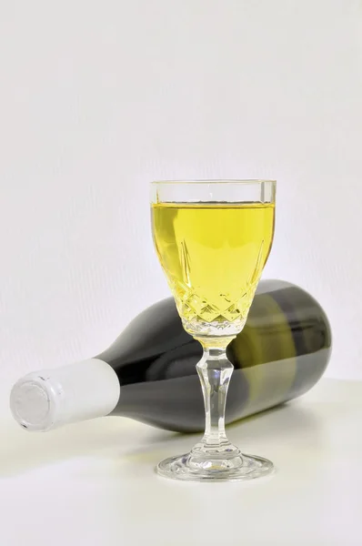 White wine in crystal glass and a bottle — Stock Photo, Image