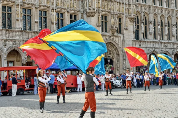 Artistas no identificados con banderas participan en la ceremonia de plantación de Meyboom en Grand Place —  Fotos de Stock