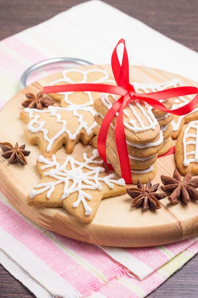 Biscoitos de gengibre de Natal em tábua redonda de madeira — Fotografia de Stock