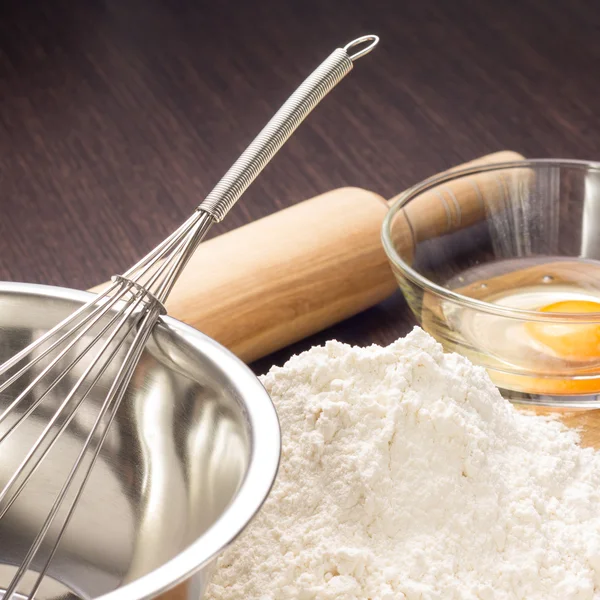 Baking ingredients with rolling-pin on board — Stock Photo, Image