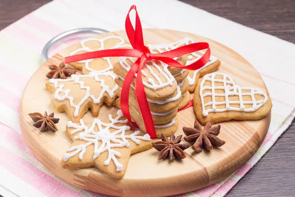 Christmas Gingerbread cookies on wooden round board — Stock Photo, Image