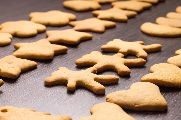 Gingerbread cookies bear in dance with hearts and stars — Stock Photo, Image