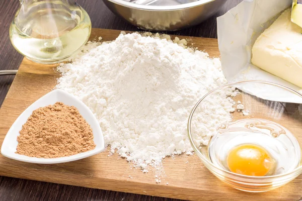Baking ingredients with rolling-pin on board — Stock Photo, Image