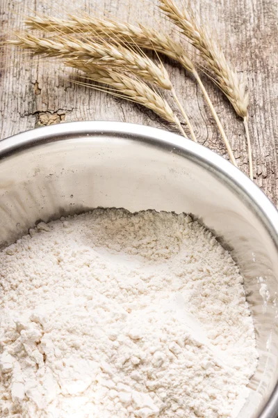 Mixing wheat flour in metallic bowl — Stock Photo, Image