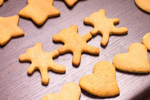Gingerbread cookies bear in dance with hearts and stars — Stock Photo, Image