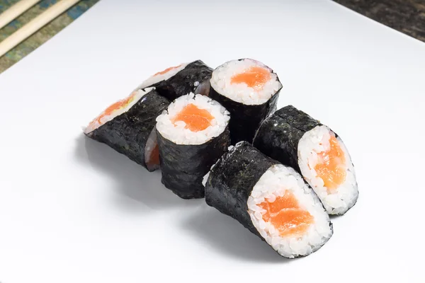 Makisushi na białym talerzu. owoce morza tradycyjnych maki sushi rolki z pałeczkami — Zdjęcie stockowe