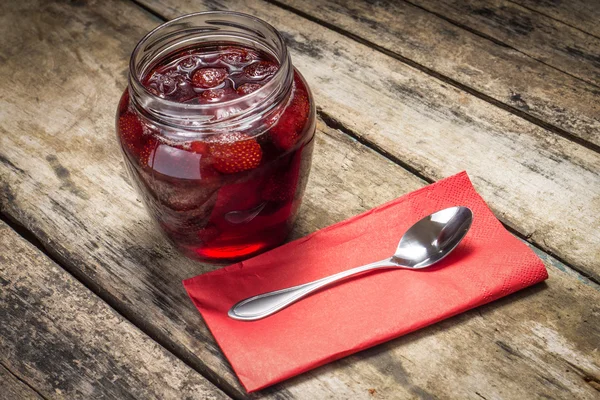 Strawberry jam with spoon served on wood background — Stock Photo, Image