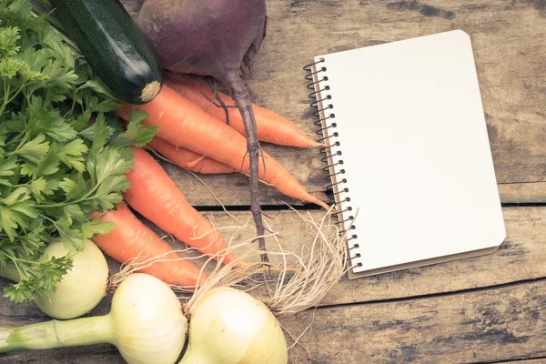 Recipe background. Fresh vegetables with blank page of cookbook — Stock Photo, Image