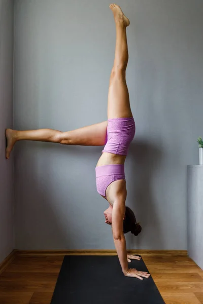 Young woman practicing yoga at home in the morning — Zdjęcie stockowe