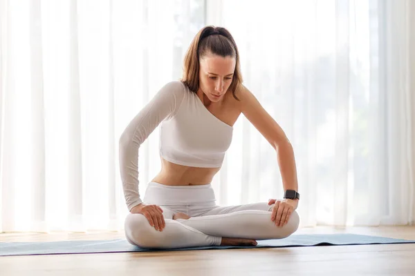 Yoga breathing morning routine image background. Young beautiful woman in white sportswear doing yoga breathing in the morning