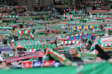 Wroclaw, POLAND - March 17: Match T-Mobile Ekstraklasa between Wks Slask Wroclaw and Podbeskidzie Bielsko-Biala, supporters with scarf of Wks Slask Wroclaw in action on March 17, 2013 in Wroclaw, Pol clipart
