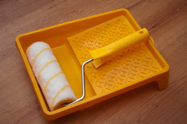 Paint rollers and brush on yellow tray — Stock Photo, Image