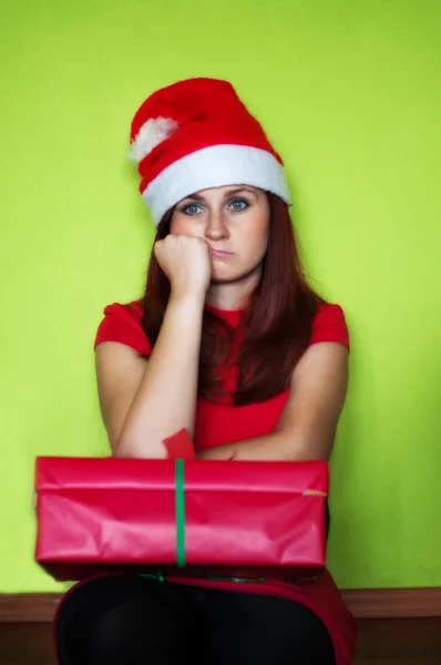 Bored and disappointed woman holding present — Stock Photo, Image
