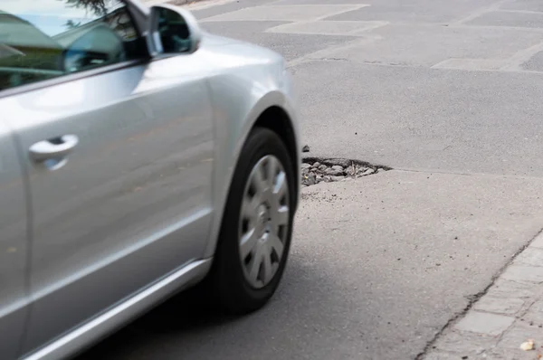 Asphaltlöcher im Straßenbett. Auto in Bewegung. — Stockfoto