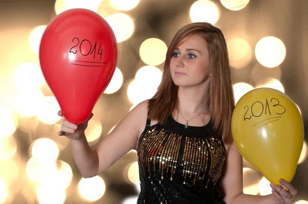 Mujer joven sosteniendo globos en año nuevo —  Fotos de Stock