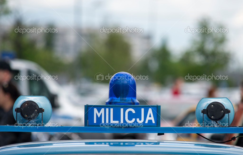 Polish Milicja (Old Police) sign on a old car