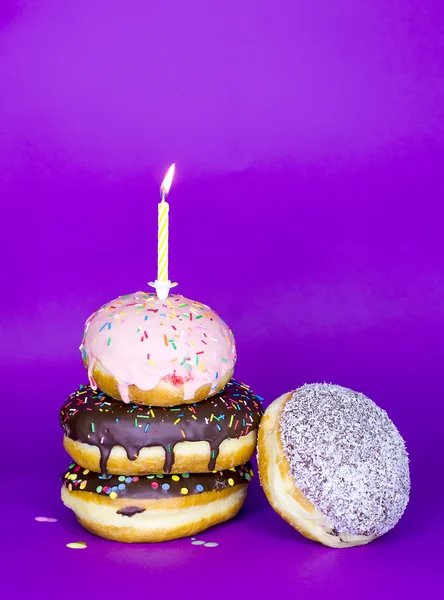Donuts tower with candle — Stock Photo, Image