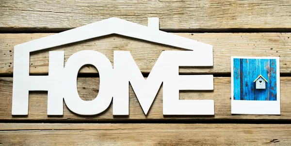 Home sign next to the photo — Stock Photo, Image