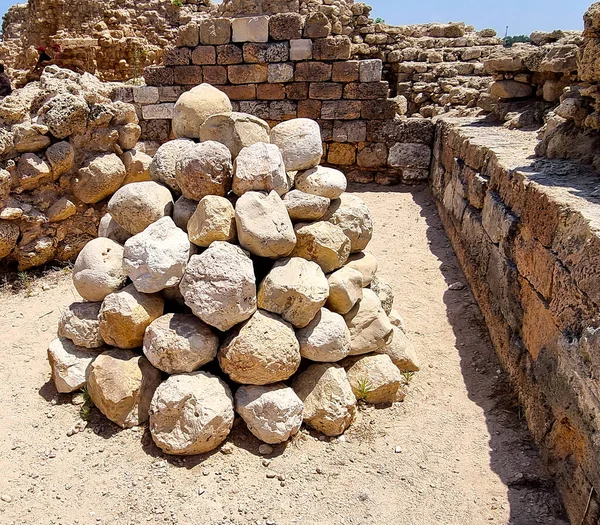Stone balls for a catapult from the time of the Crusades in the fortress of the Crusaders in the Apollonia National Park in Israel
