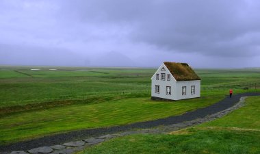 Lonely standing rural house in the boundless expanse of Iceland