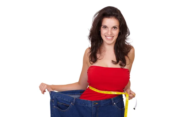 Young happy beautiful slim girl in her old jeans isolated — Stock Photo, Image