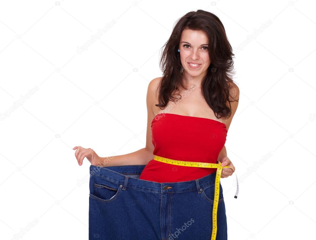 Young happy beautiful slim girl in her old jeans isolated