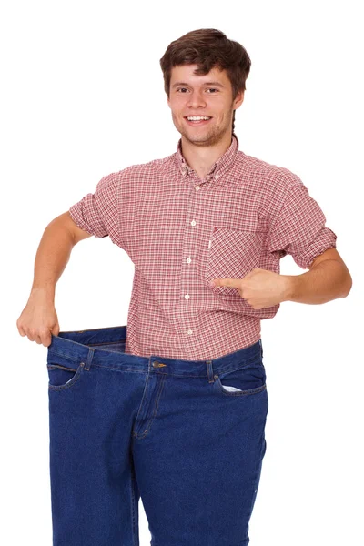 Jovem magro feliz bonito cara em jeans, isolado em branco — Fotografia de Stock