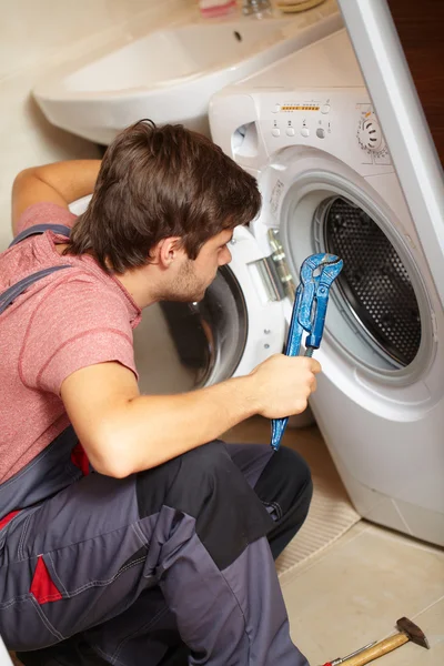 Young attractive worker in uniform, background — Stock Photo, Image