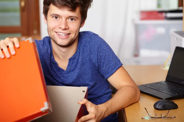 Young attractive guy with boxes, background — Stock Photo, Image