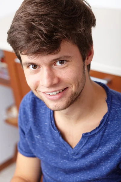 Young handsome smiling guy, background — Stock Photo, Image